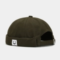 Dark olive green docker hat with embroidered smiley face tag and adjustable back strap - Square Smile Army Green