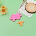 DIY pink silicone bee mold with finished orange resin bee on a minimalist background - 2-Cavity Bee