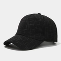 Close-up of black baseball cap with fine white grid texture and curved brim detail - Black