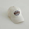 Detailed view of NICE letter embroidery on cream cotton baseball cap for kids - 52-54cm (3-8 Years) / Off White