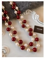 Macro detail of vintage red beads and white pearls connected by fine gold metal links - Gold-Red-White