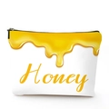 Close-up of white linen cosmetic bag with a golden honey drop design and zipper closure - Honey Drip