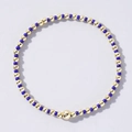 Minimalist handmade beaded bracelet with navy blue beads and gold metallic spheres - Deep Blue and Gold