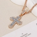 Macro shot of gold cross pendant with cubic zirconia stones on a classic box chain - Cross / Gold Chain with White Pendant