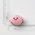 Handmade crochet pink peach plush keychain with soft knit texture and cute face detail - Smiley Pink Peach