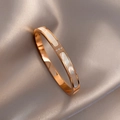 Detail of rose gold bangle with white mother-of-pearl inlay and sparkling zircon accents - Simple Polishing / Rose Gold