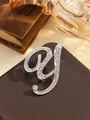 Elegant silver letter G brooch with sparkling rhinestones on a vintage leather background - Silver Letter Y
