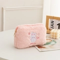 Pink plush cosmetic bag with bear embroidery and 'DOWN' text on white tabletop - Heart Bunny