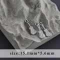 Macro shot of silver guitar pendants with inlaid zircons on rock, size 15.1mm x 5.6mm - Guitar Style (M100307)