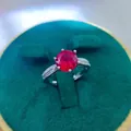 Detail view of a 2-carat red ruby ring with six-prong setting and side diamonds - A9 Open Type / Red