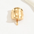 Dettaglio ravvicinato di un gancio per capelli in metallo dorato con superficie materica - Oro Piccolo D4329