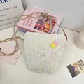 Süße cremefarbene Handytasche mit Regenbogenstickerei und kleinen Plüschbommeln - Cremeweiß