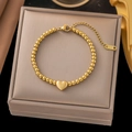 18K gold plated stainless steel bead bracelet featuring a 3D heart pendant on gray jewelry box - Gold Bead Heart Pendant Bracelet