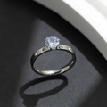 Sleek silver titanium steel ring with a large six-prong solitaire and side diamond accents - US 6 / Silver