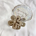 Matte khaki flower hair claw clip with cutout petals on a decorative shell tray - Matte Khaki