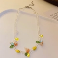 Handmade beaded necklace with orange-pink flowers and green leaves on white tray - Multicolor Flower