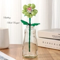 Elegant green flower building block in a glass vase on a wooden table setup - Balloon Flower 260-30 / Bag Packaging
