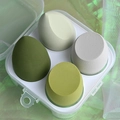 Set of 4 soft beauty blenders in green and grey shades inside a clear storage box - Avocado Green 4-Piece Set
