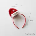 Diadema roja de Navidad con mini gorro de Papá Noel y detalle de texto merry dorado - Diadema Con Gorro De Navidad Estilo C
