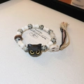 Detail of handmade ceramic cat bead bracelet with bone charms and woven tassels - 8# Black Cat