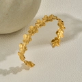 Polished gold stainless steel open bangle with continuous five-petal flower pattern - Gold Textured Flower