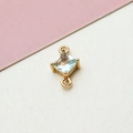Detail of gold-plated geometric rhombus connector with light blue zircon and dual loops - Light Blue