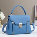 Detail view of blue lychee texture leather handbag with gold metal hardware and lock buckle - Blue