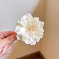 Delicate cream mesh flower hair clip with realistic satin petals and pink center - Champagne Camellia