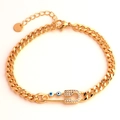 Macro detail of gold Cuban link bracelet with evil eye safety pin and clear zircons - 18K Gold / Blue Evil Eye