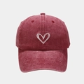 Close-up of vintage washed burgundy baseball cap featuring white heart embroidery details - Burgundy