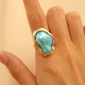Close-up of golden baroque ring featuring a unique irregular blue gemstone on finger - Gold Irregular Blue Pearl Ring (A-1164)