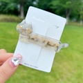 Cute acetate cat hair clip with pearlescent finish and pearl collar detail on a card - Colorful Grey Cat