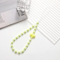 Detail of beaded phone strap with green beads and a bright yellow heart charm decoration - Green