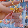 Pink rhinestone bear keychain with matching leather strap and gold metal hardware - Pink