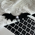 Detail of gothic black bat wing hair clip with skull center on a soft knit background - 1# Skull Wing Hair Clip