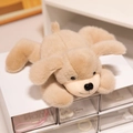 Soft cream-colored plush puppy toy in a lying position for girls and children - Dog