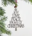Close-up of silver metal Christmas tree pendant with JOY and PEACE text on a pine branch - Blessing Christmas Tree