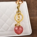 Glitter pink apple keychain with gold leaf and clasp on a luxury quilted handbag - Glitter Pink