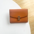 Orange red lychee pattern leather wallet featuring a unique silver blade metal clasp - Orange