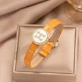 Close-up of orange leather bracelet with golden H logo and white shell inlay on gift box - Orange