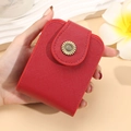 Mini red cross-grain leather makeup bag featuring a vintage sunflower metal snap closure - Red