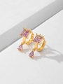 Macro detail of gold-plated earrings featuring square and teardrop pink cubic zirconia - Pink