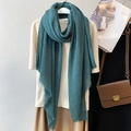 Teal blue linen cotton scarf with crinkled texture and raw edges in stylish display - Cyan Blue