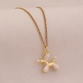 Close-up of a pink balloon dog pendant with a delicate golden chain necklace - White