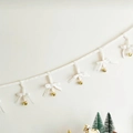 Christmas bunting featuring white ribbons with bows and hanging gold bells ornaments - White Bow String