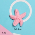 Detail view of pink resin starfish accessory with 2x2.1cm size and matte finish - Pink Starfish