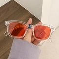 Retro square sunglasses with transparent frames and vibrant orange tinted lenses - Transparent Red