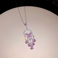 Silver-plated bow necklace with pink and white crystal tassels on a display plate - Necklace - Silver - Pink
