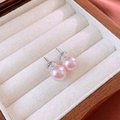 Macro shot of elegant pink pearl earrings with silver posts on white velvet lining - Pink Pearl Studs (9mm)