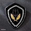 Shield-shaped brooch badge in black and gold with 4x5cm dimensions for suits - Shield Badge